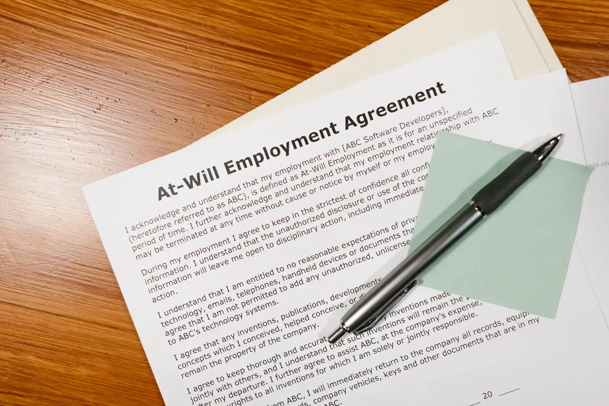 Document d'emploi imprimé avec un stylo sur un bureau en bois